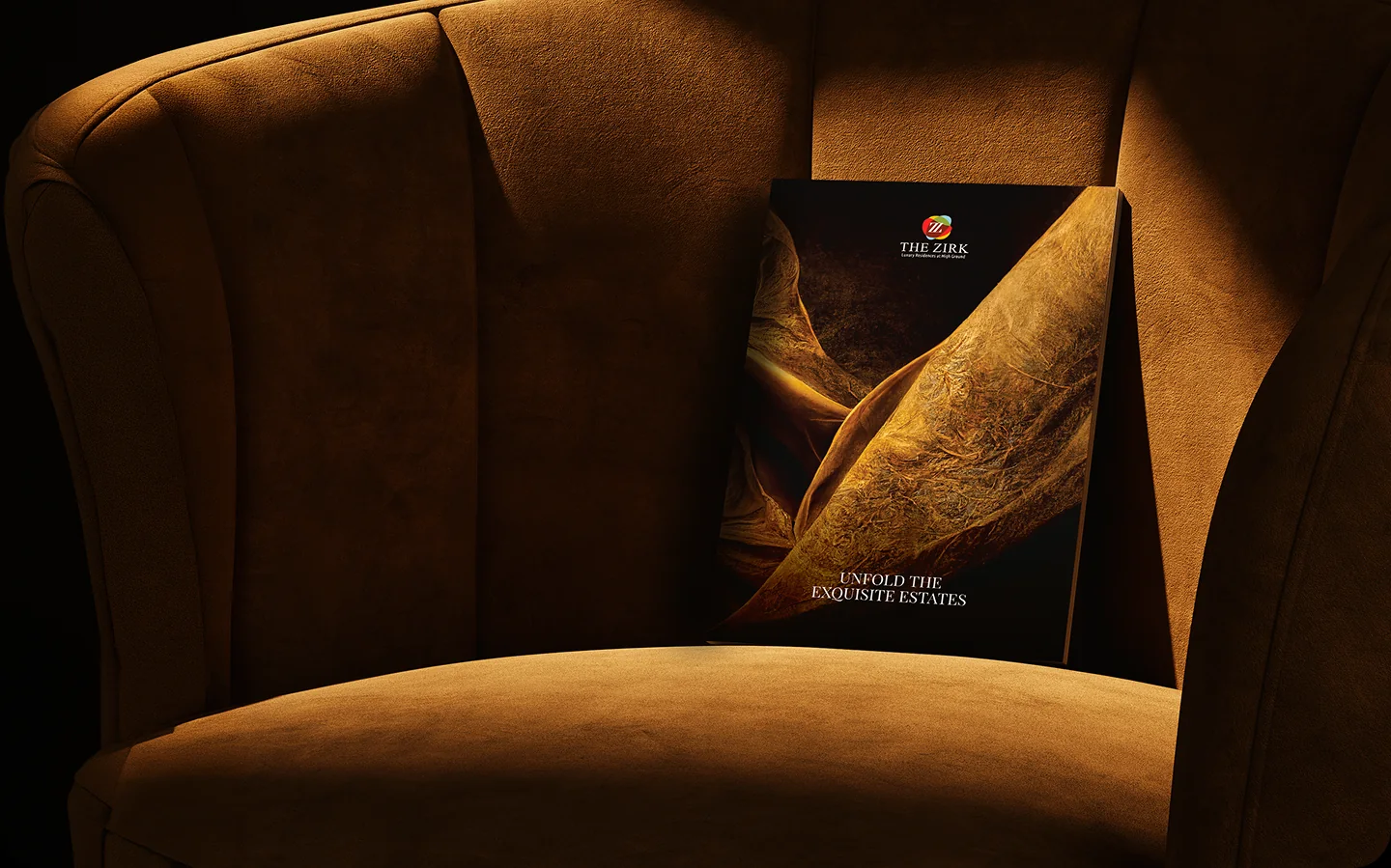 The Zirk property brochure on a velvet armchair